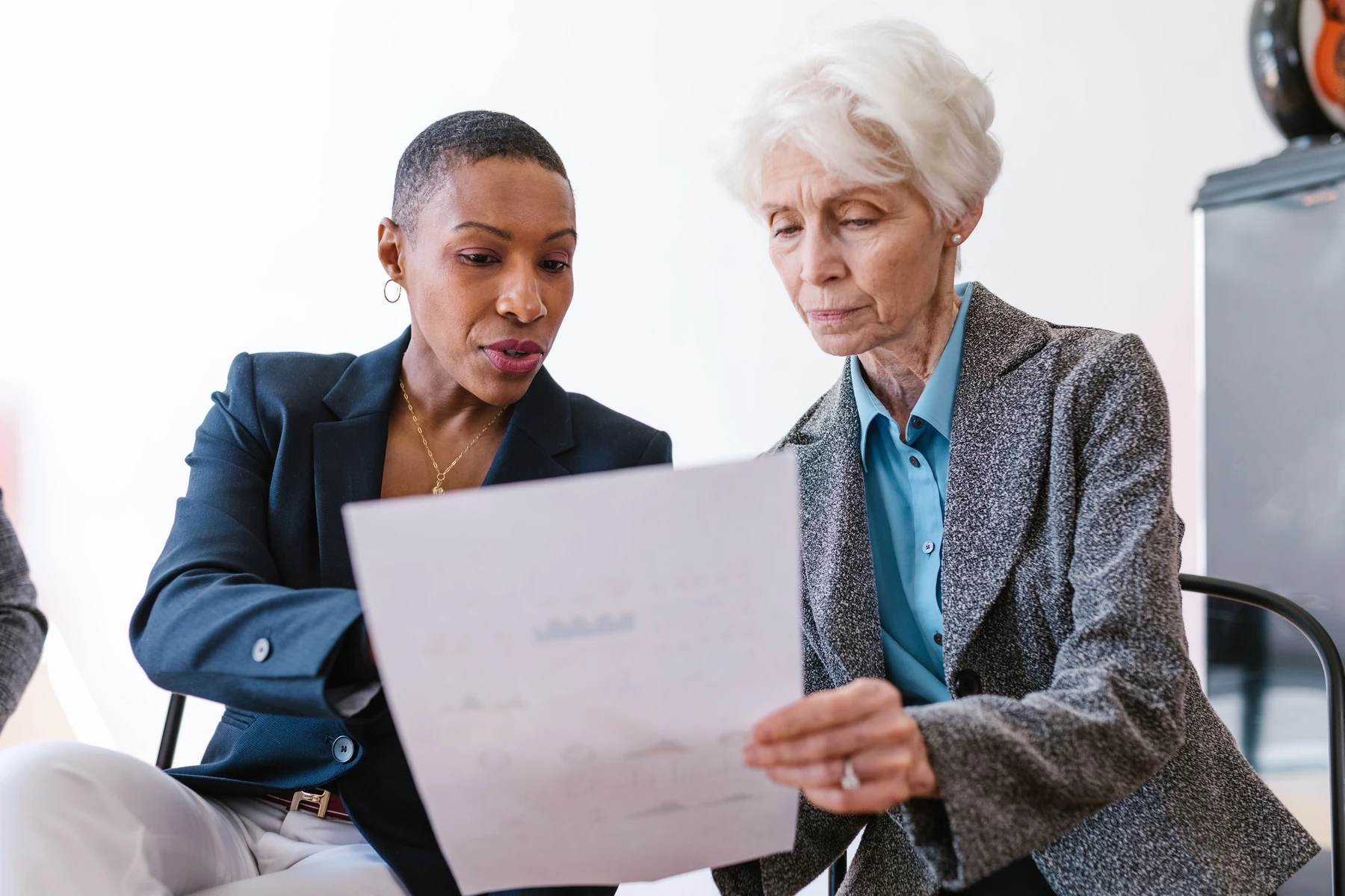 Two professionals reviewing a document together
